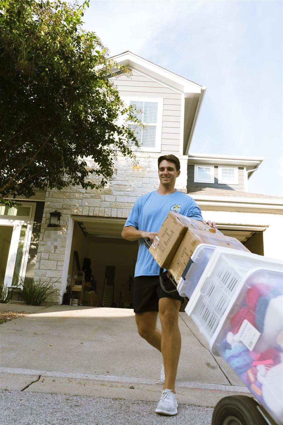 Butter Brothers mover wheeling boxes and bins from a home to the truck